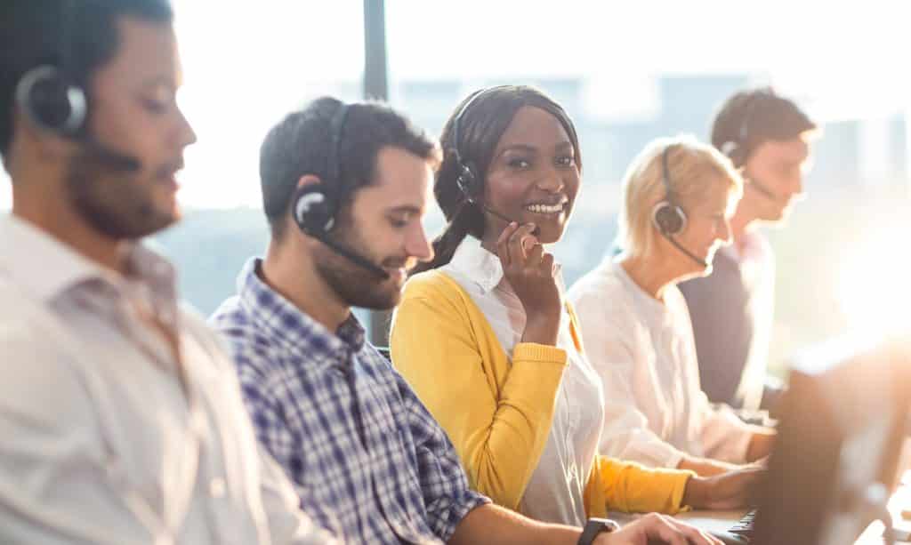 Team working on computer with headset